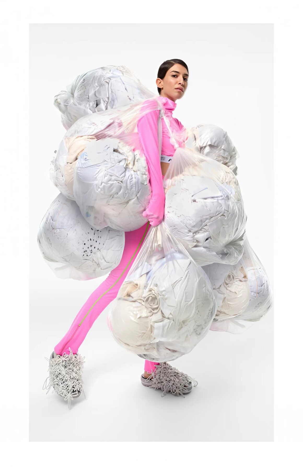 Model with bags of clothes featured in the re:FRAME photo exhibit